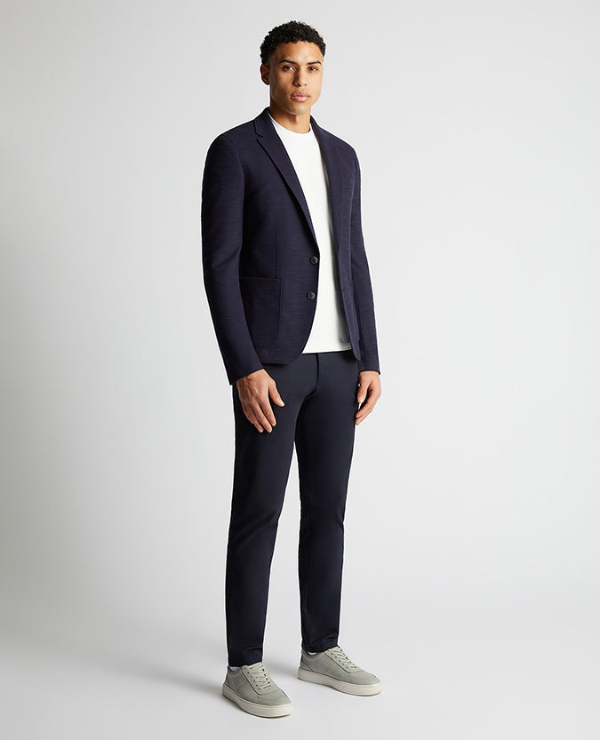 Man wearing a navy Slim Fit Cotton-Blend Stretch Jacket