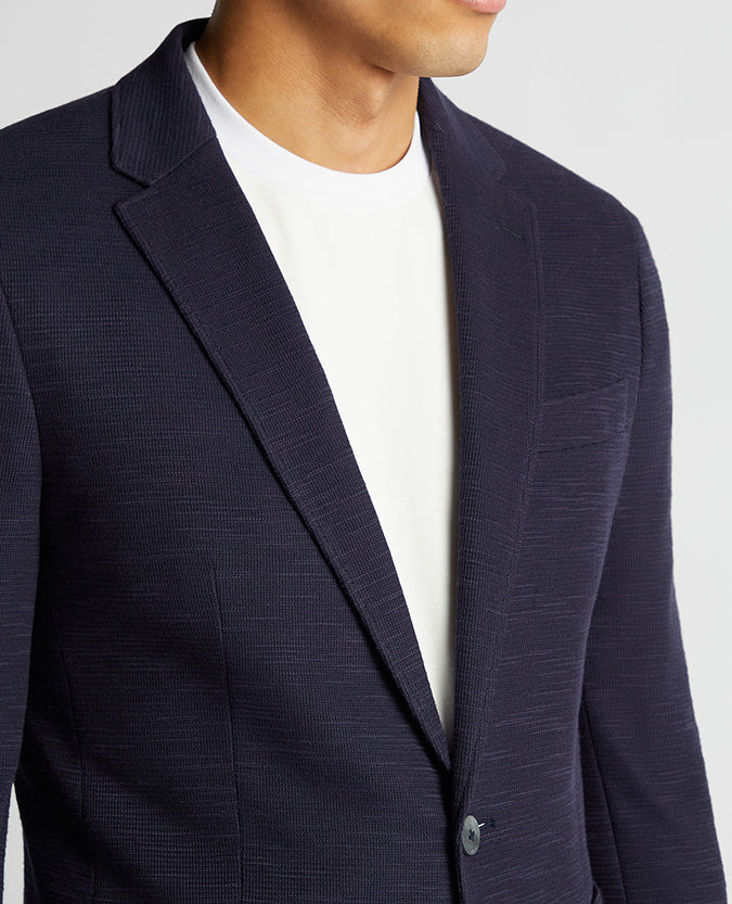 Man wearing a navy Slim Fit Cotton-Blend Stretch Jacket