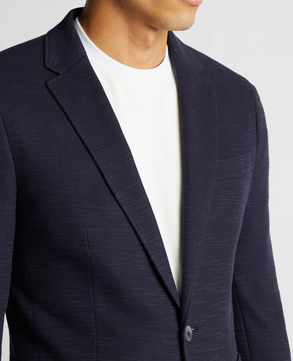 Man wearing a navy Slim Fit Cotton-Blend Stretch Jacket