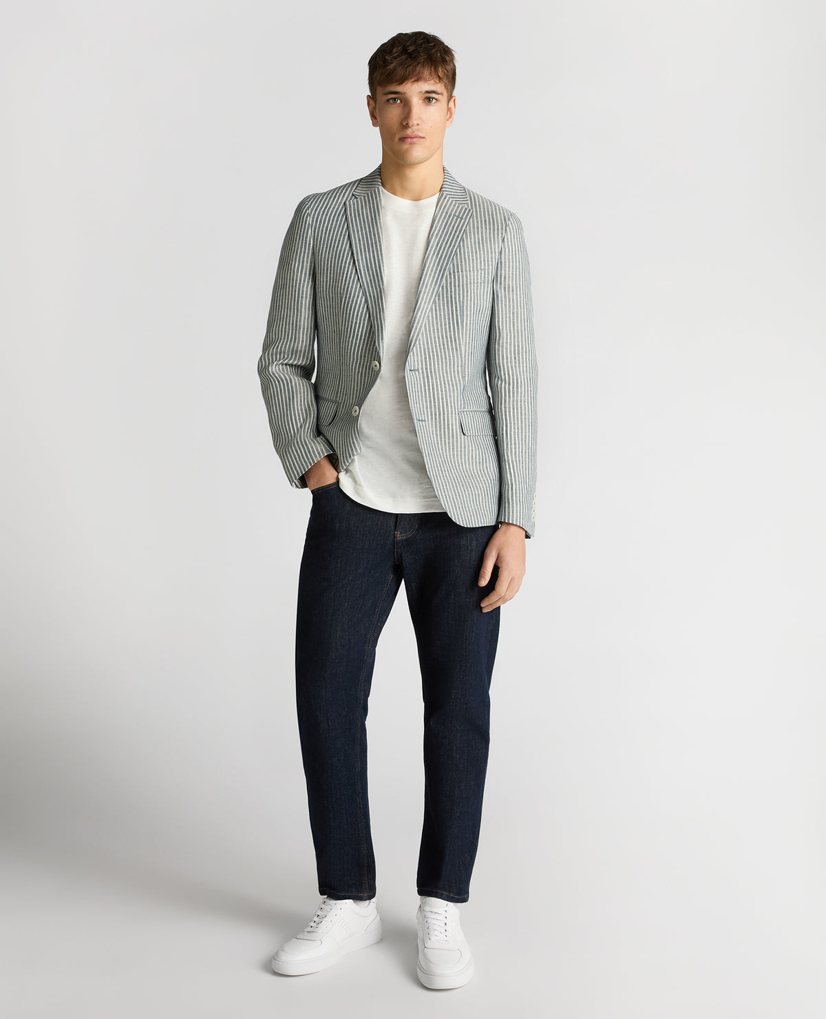 Man wearing a navy Slim Fit Linen-Blend Pinstripe Jacket