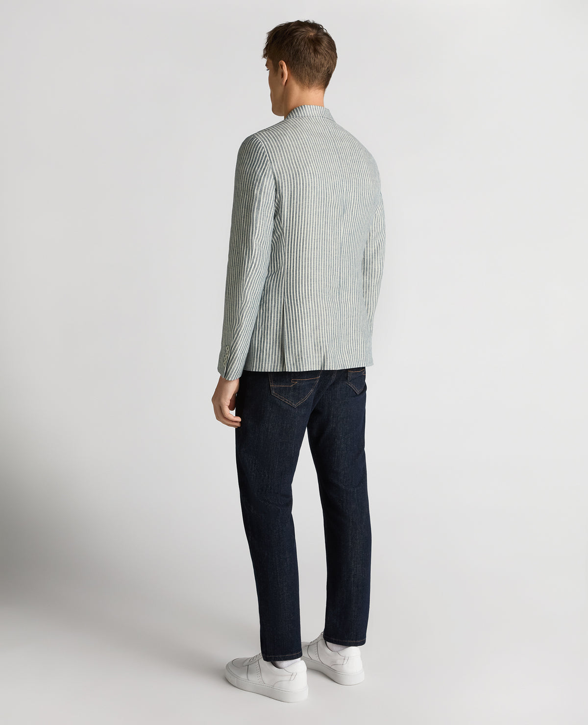Man wearing a navy Slim Fit Linen-Blend Pinstripe Jacket
