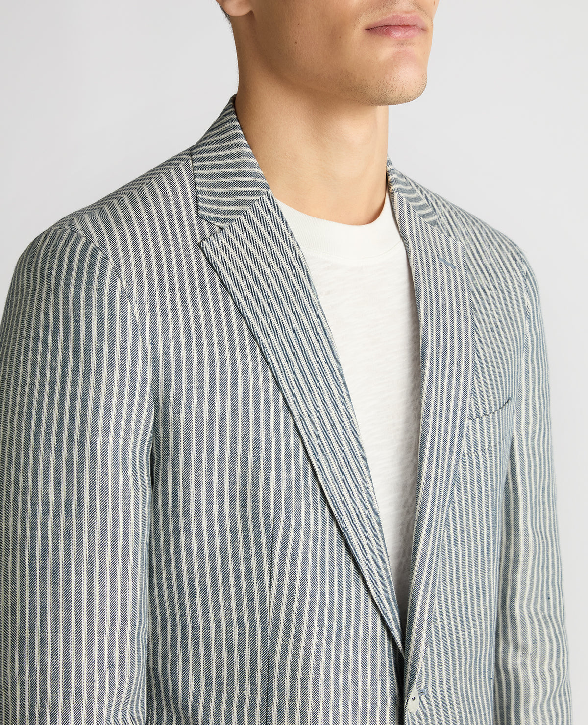 Man wearing a navy Slim Fit Linen-Blend Pinstripe Jacket