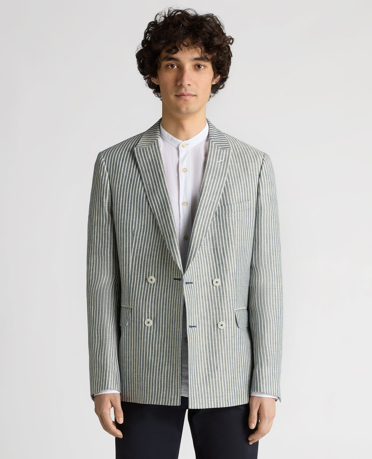 Man wearing a navy Slim Fit Linen-Blend Double-Breasted Pinstripe Jacket