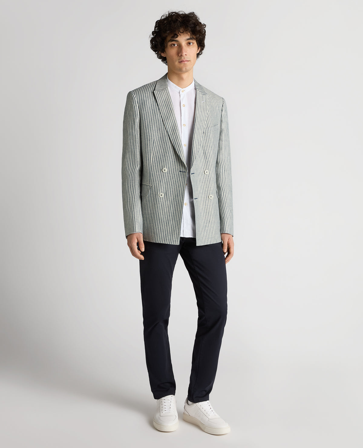 Man wearing a navy Slim Fit Linen-Blend Double-Breasted Pinstripe Jacket