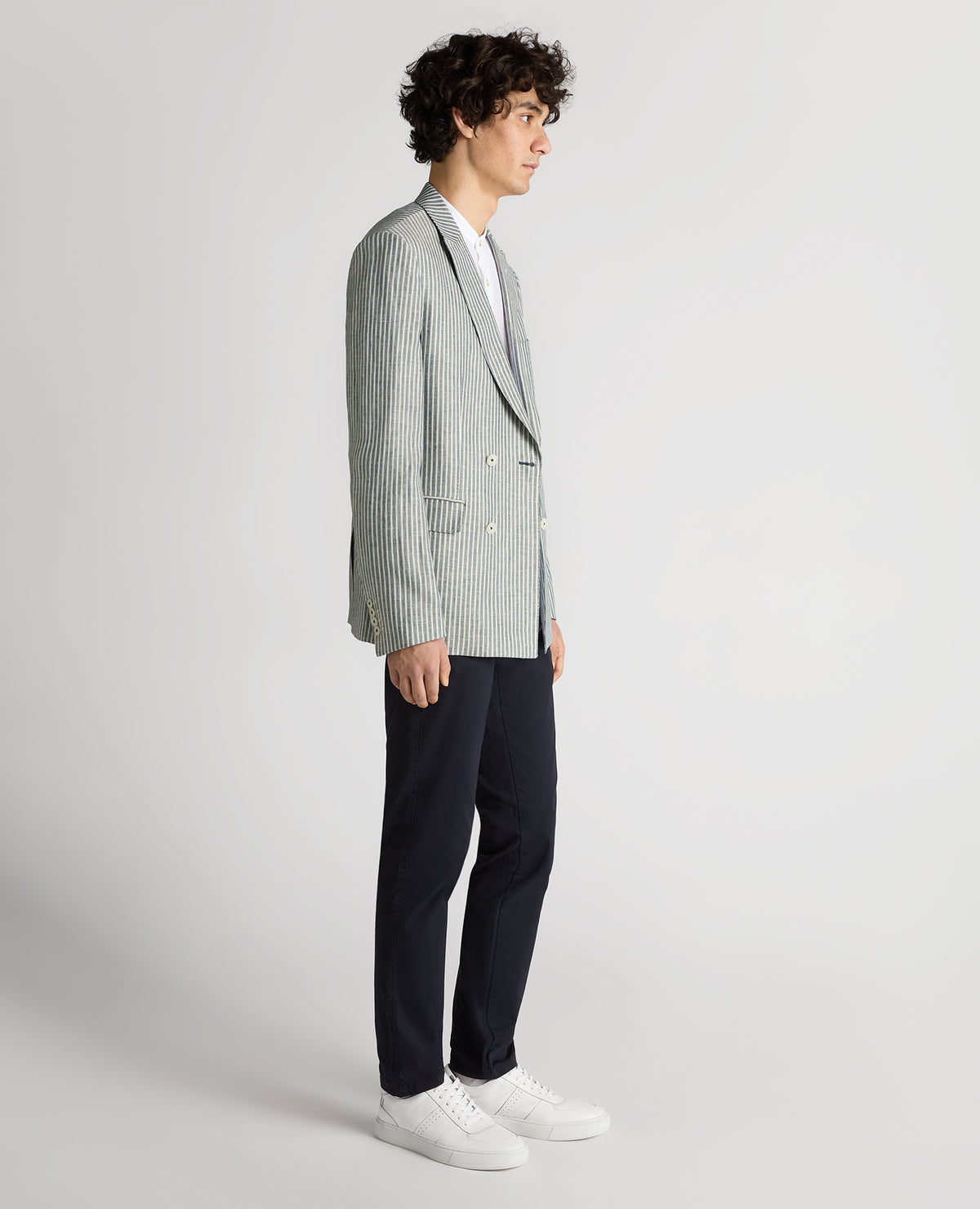 Man wearing a navy Slim Fit Linen-Blend Double-Breasted Pinstripe Jacket