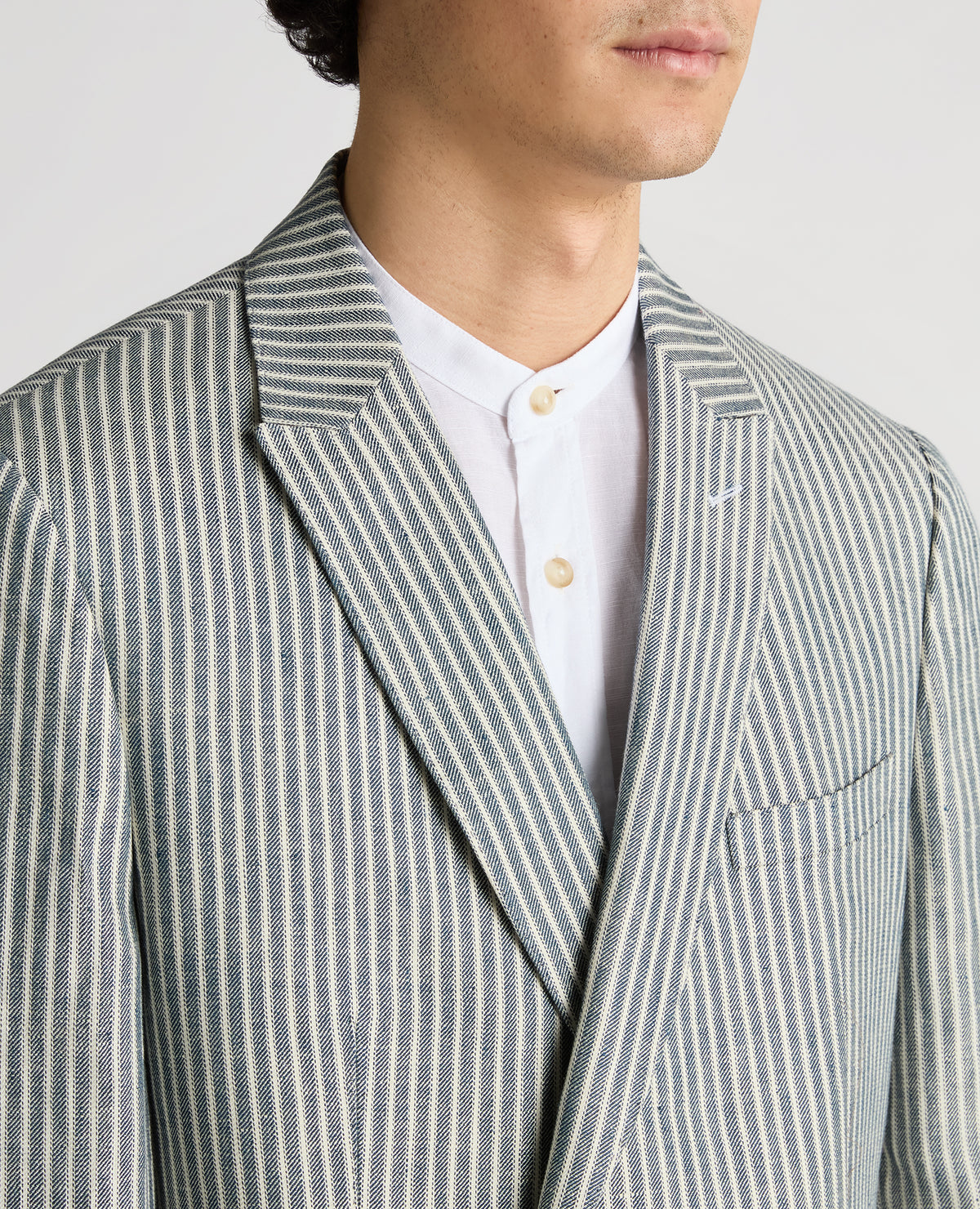 Man wearing a navy Slim Fit Linen-Blend Double-Breasted Pinstripe Jacket