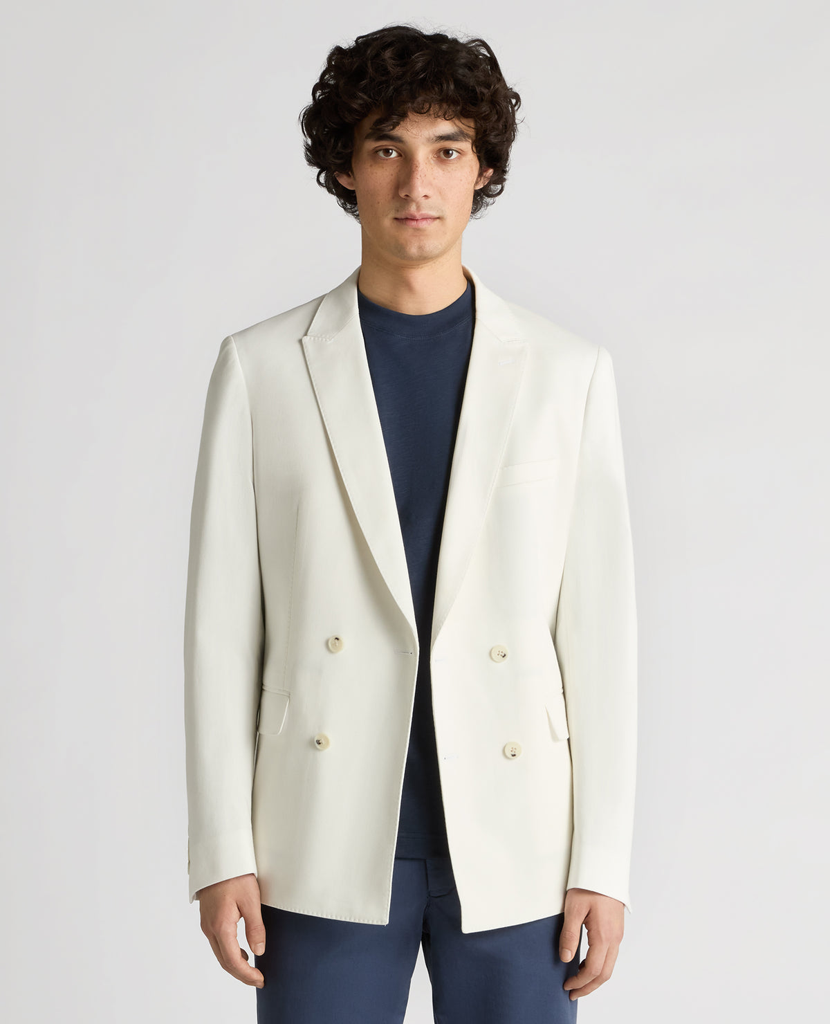 Man wearing a white Slim Fit Cotton-Stretch Double-Breasted Jacket