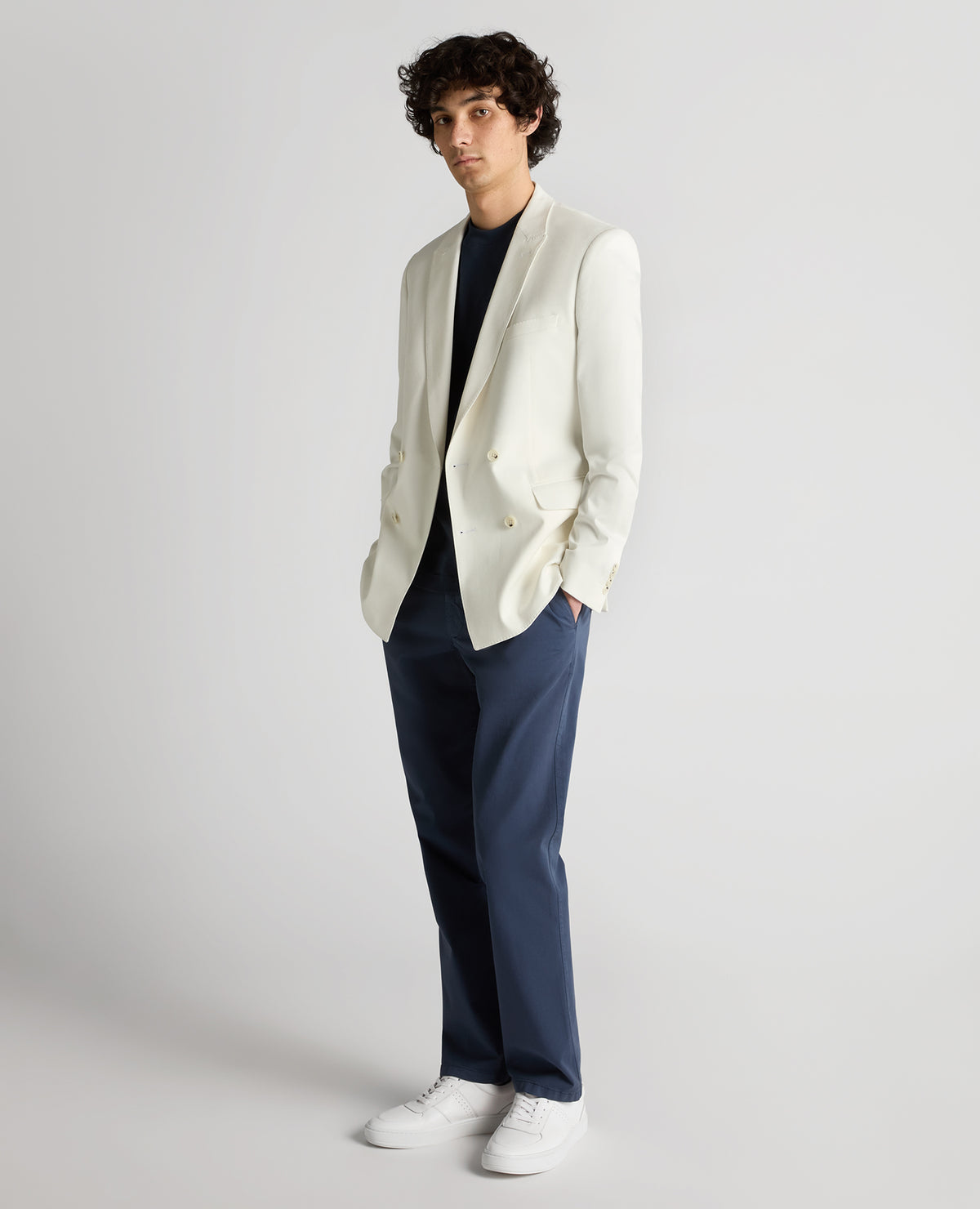 Man wearing a white Slim Fit Cotton-Stretch Double-Breasted Jacket