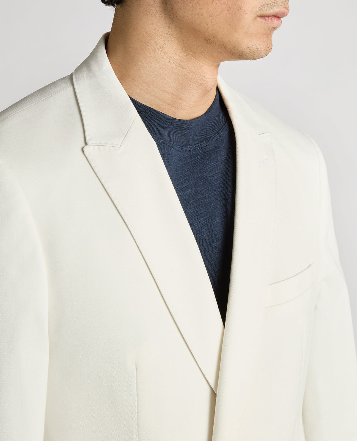 Man wearing a white Slim Fit Cotton-Stretch Double-Breasted Jacket