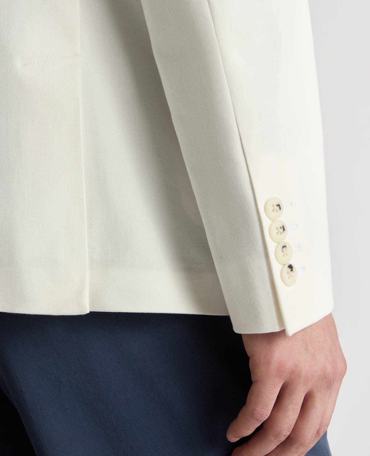 Man wearing a white Slim Fit Cotton-Stretch Double-Breasted Jacket