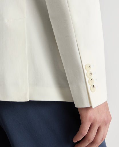 Man wearing a white Slim Fit Cotton-Stretch Double-Breasted Jacket