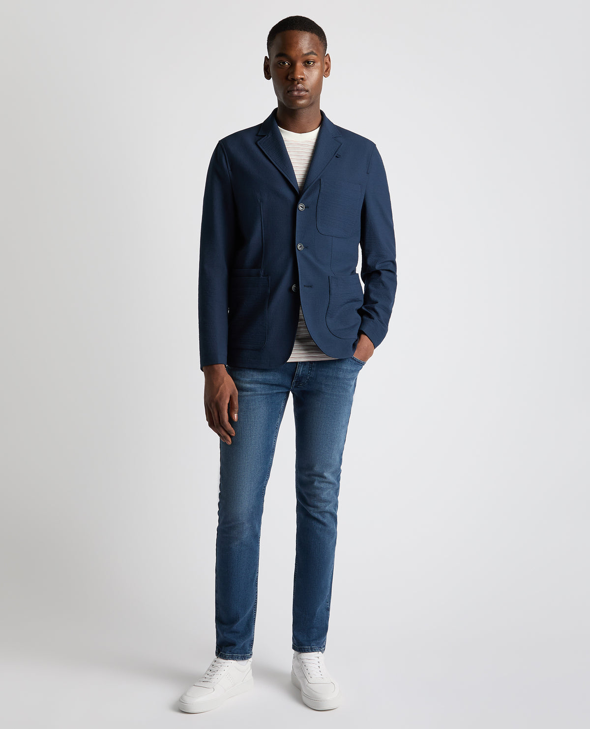 Man wearing a blue Slim Fit Seersucker De-Constructed Jacket