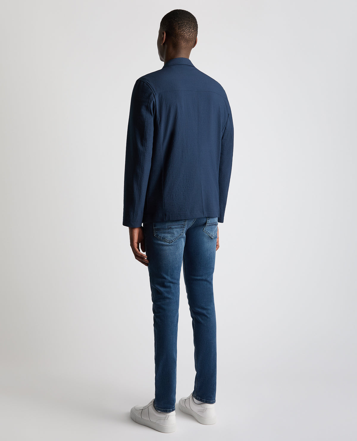 Man wearing a blue Slim Fit Seersucker De-Constructed Jacket