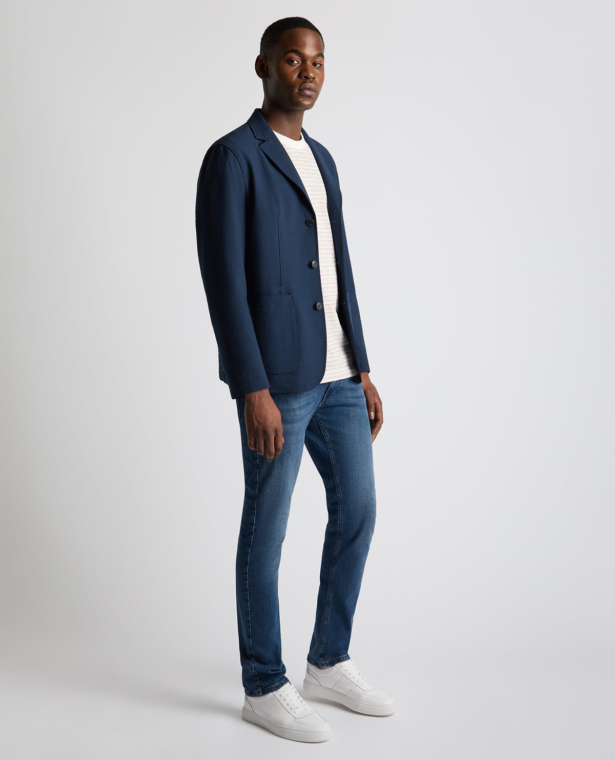 Man wearing a blue Slim Fit Seersucker De-Constructed Jacket