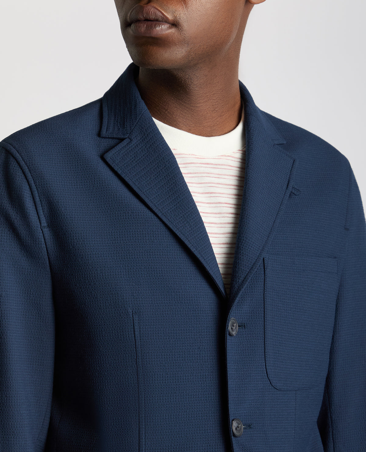 Man wearing a blue Slim Fit Seersucker De-Constructed Jacket