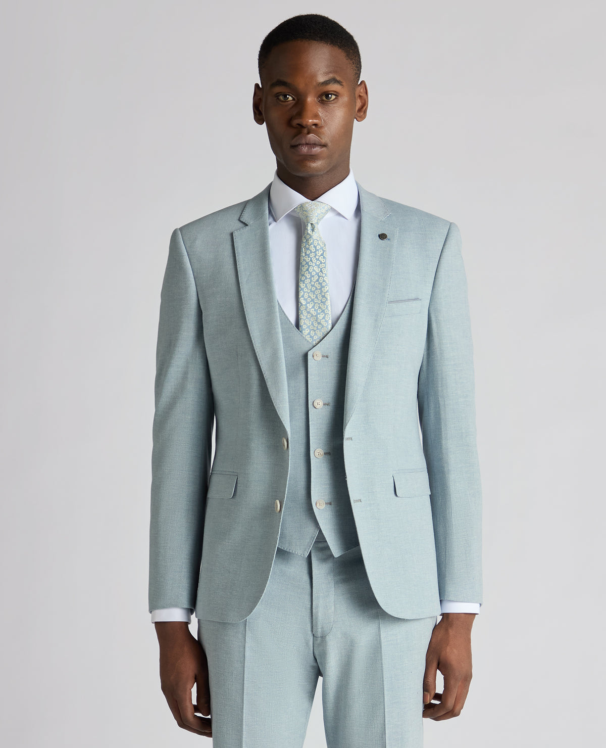 Man wearing a blue Slim Fit Linen-Blend Micro Pinstripe Suit Jacket