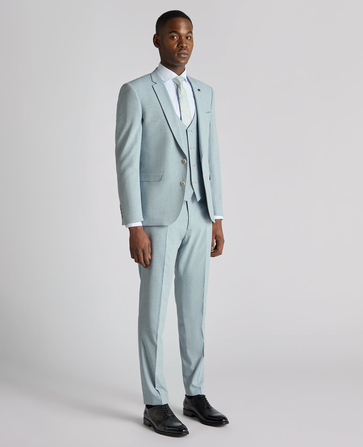 Man wearing a blue Slim Fit Linen-Blend Micro Pinstripe Suit Jacket