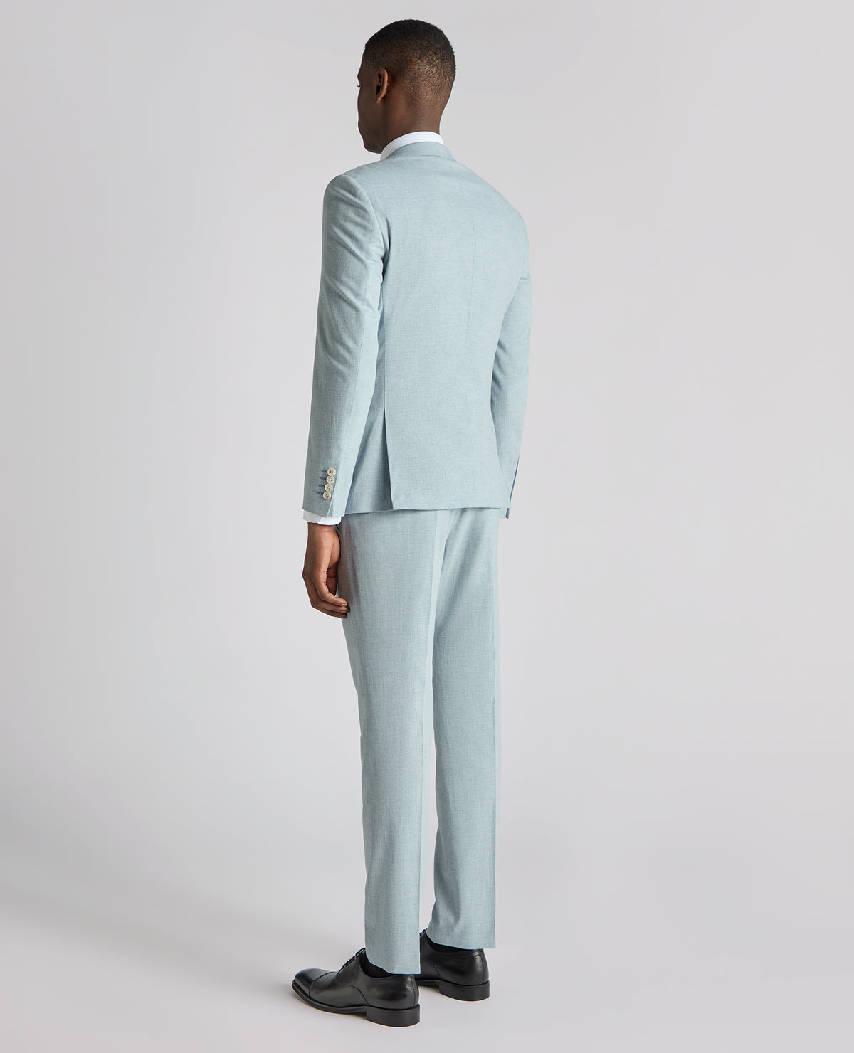Man wearing a blue Slim Fit Linen-Blend Pinstripe Suit