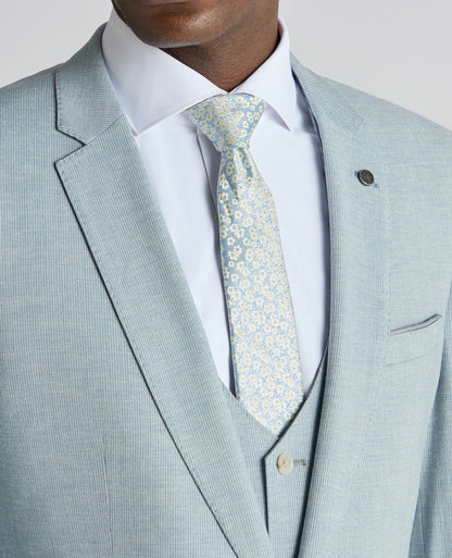 Man wearing a blue Slim Fit Linen-Blend Micro Pinstripe Suit Jacket