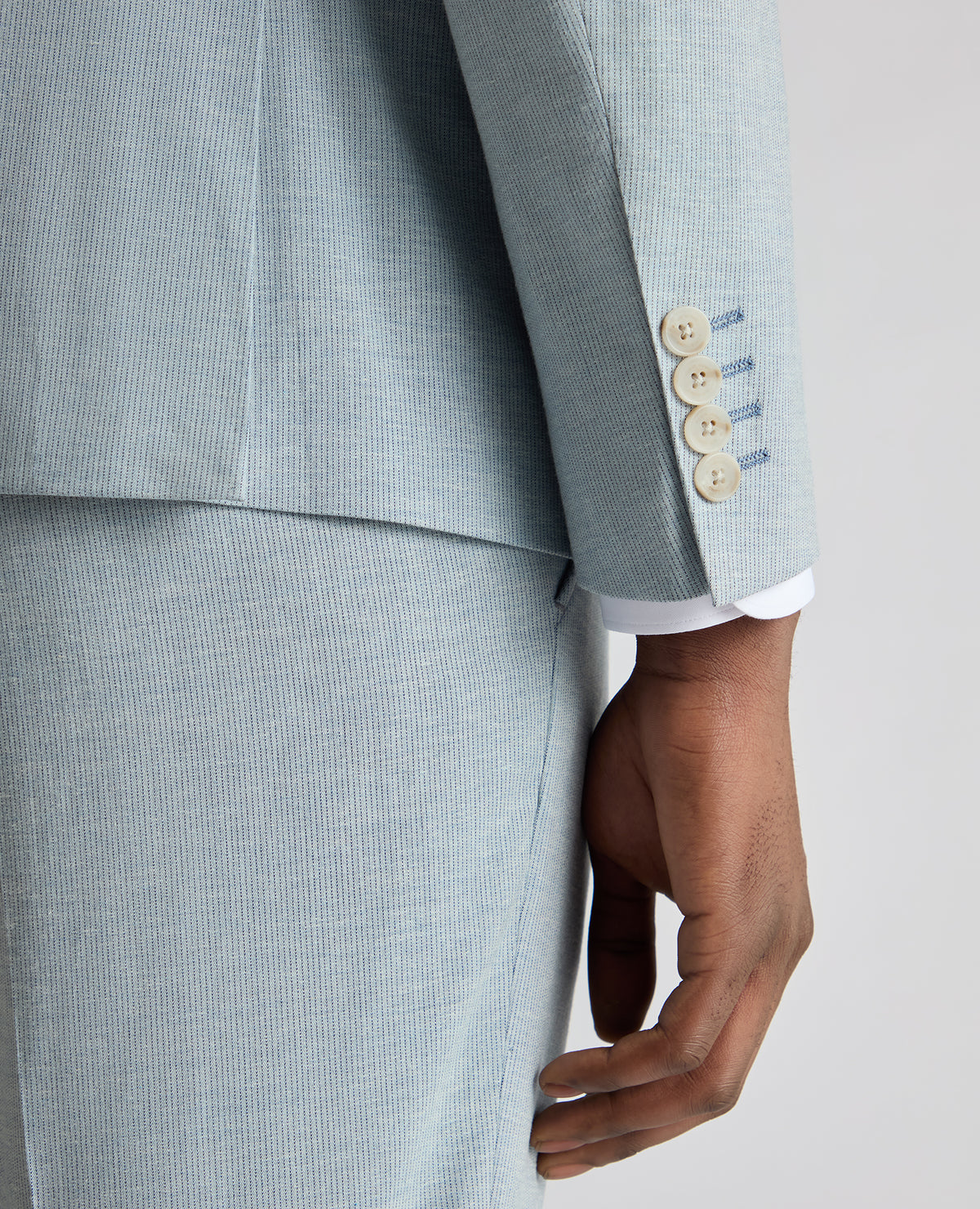 Man wearing a blue Slim Fit Linen-Blend Micro Pinstripe Suit Jacket