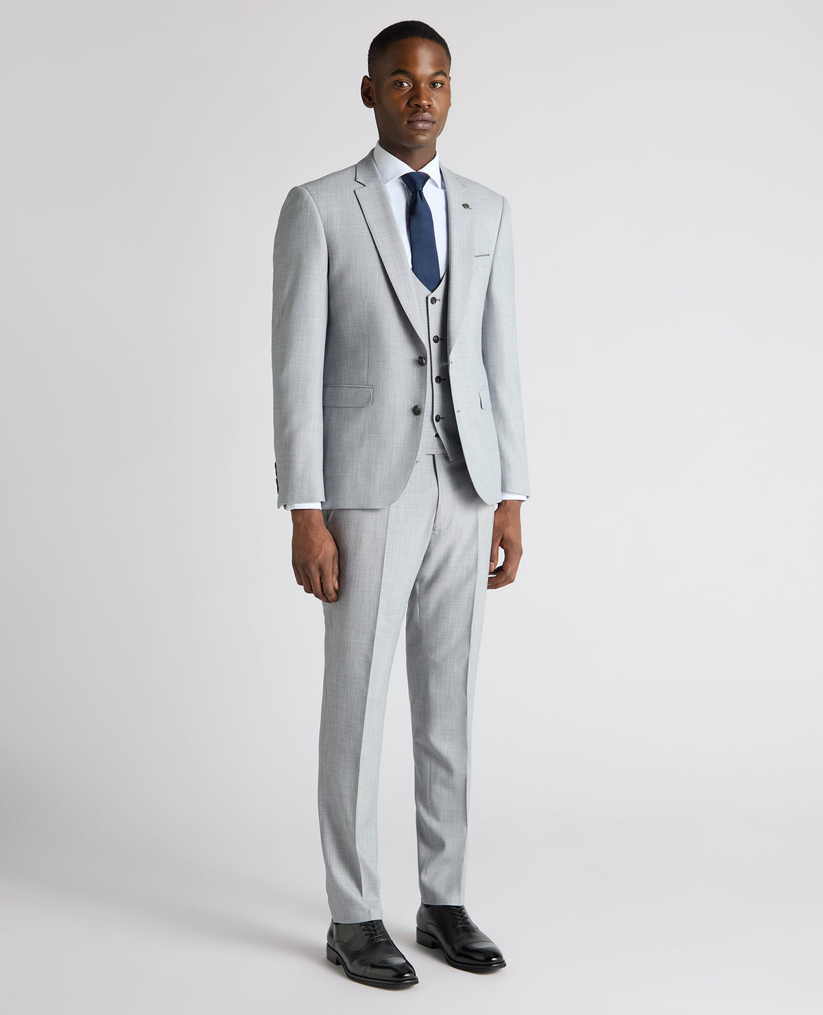 Man wearing a blue Slim Fit Micro Houndstooth Suit Jacket