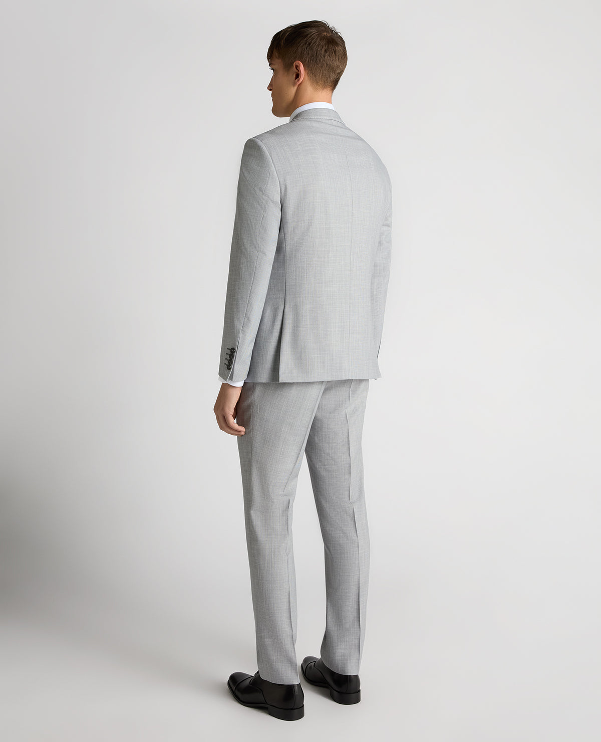 Man wearing a blue Tapered Fit Micro Houndstooth Suit Jacket
