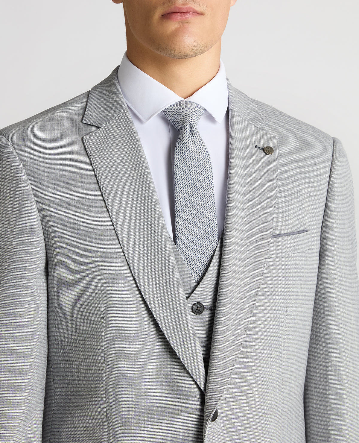 Man wearing a blue Tapered Fit Micro Houndstooth Suit Jacket