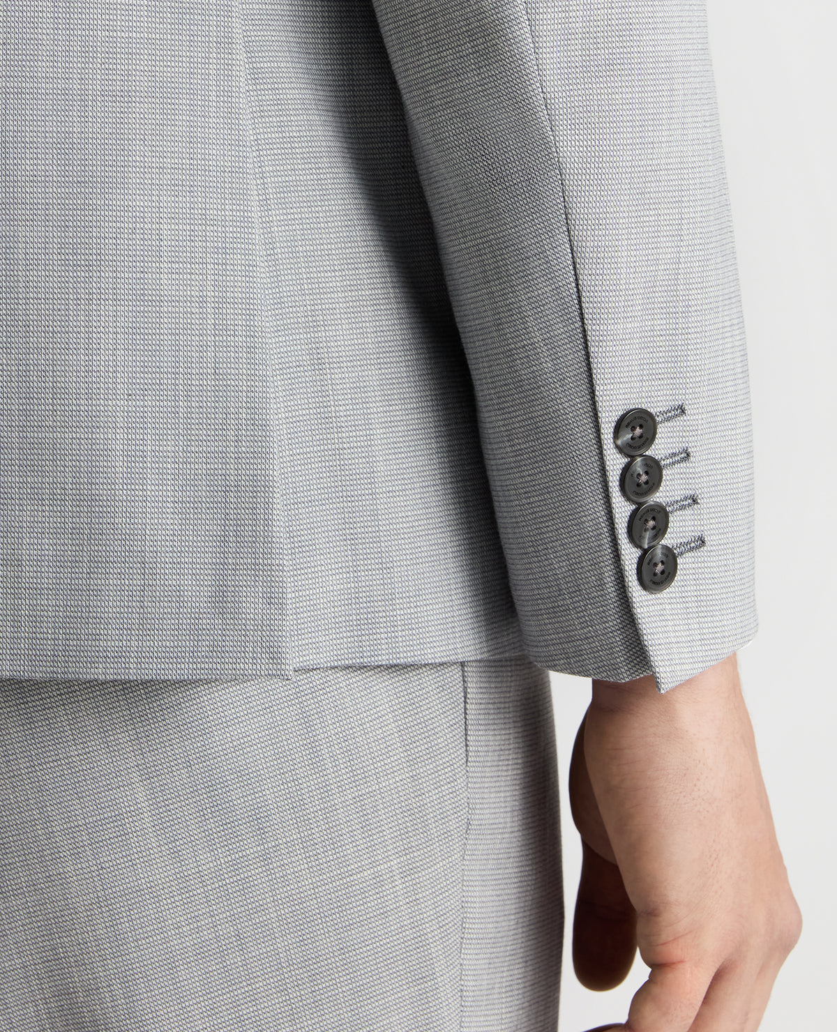 Man wearing a blue Tapered Fit Micro Houndstooth Suit Jacket