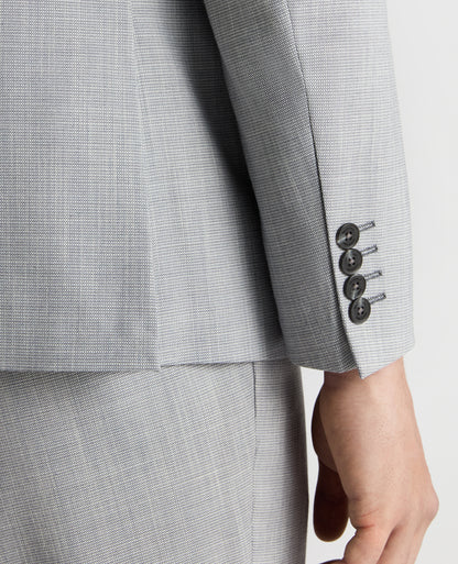 Man wearing a blue Tapered Fit Micro Houndstooth Suit Jacket