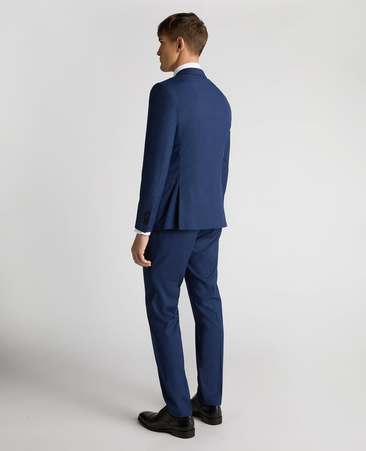Man wearing a blue Slim Fit Micro Check Stretch Suit