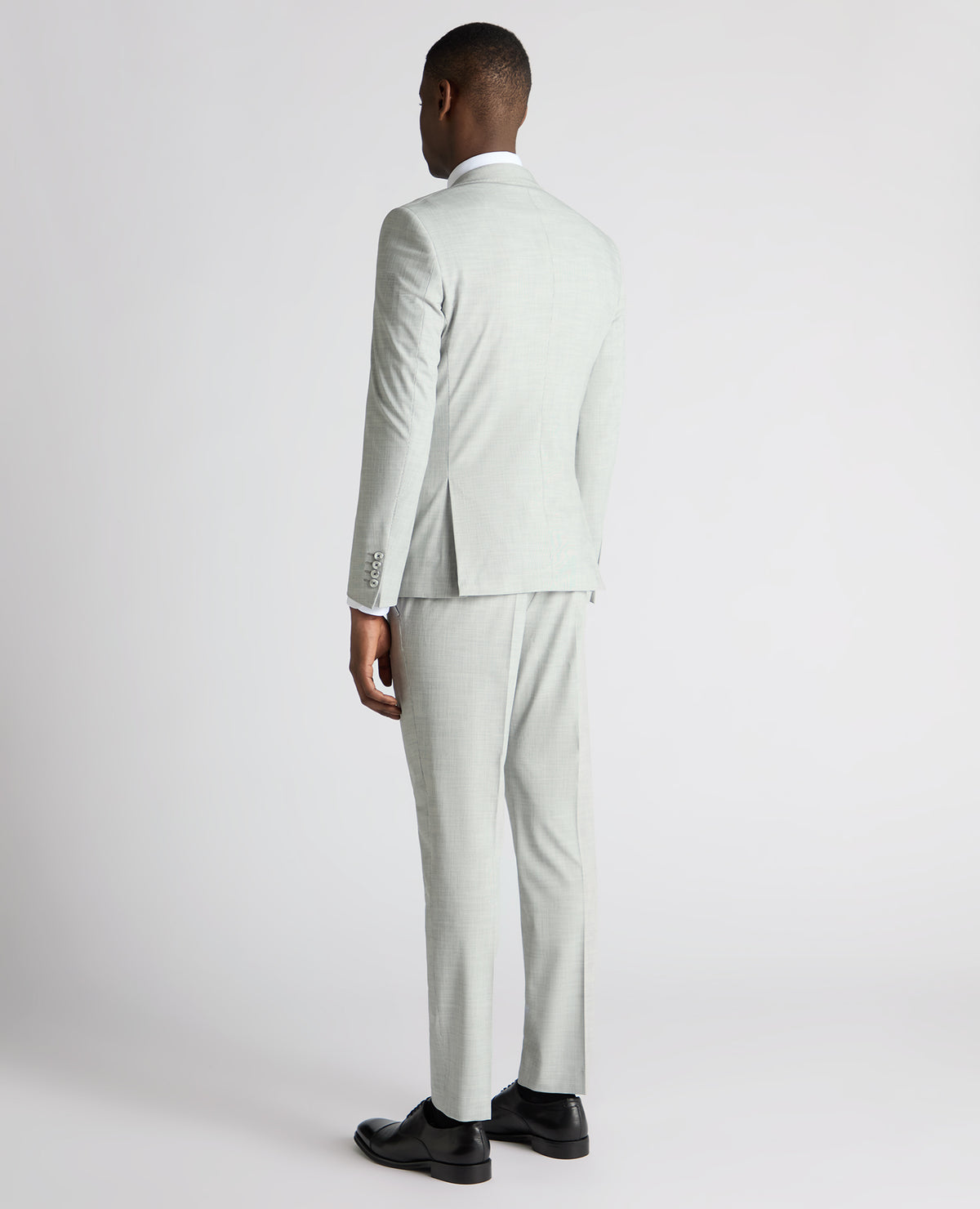 Man wearing a grey Slim Fit Stretch Micro Pinstripe Suit Jacket