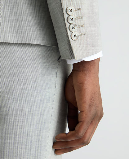 Man wearing a grey Slim Fit Stretch Micro Pinstripe Suit Jacket