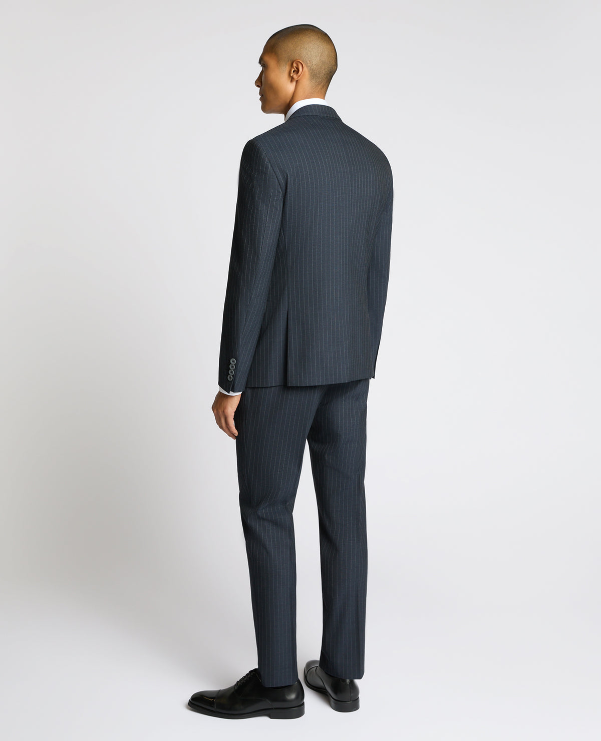 Man wearing a navy Slim Fit Stripe Stretch Jacket