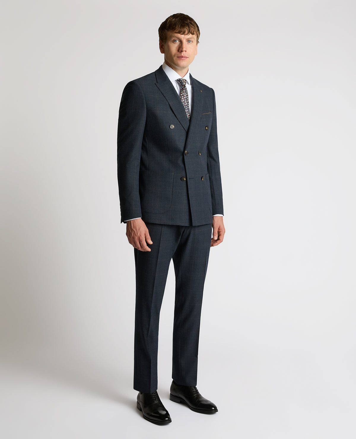 Man wearing a navy Slim Fit Double-Breasted Stretch Jacket