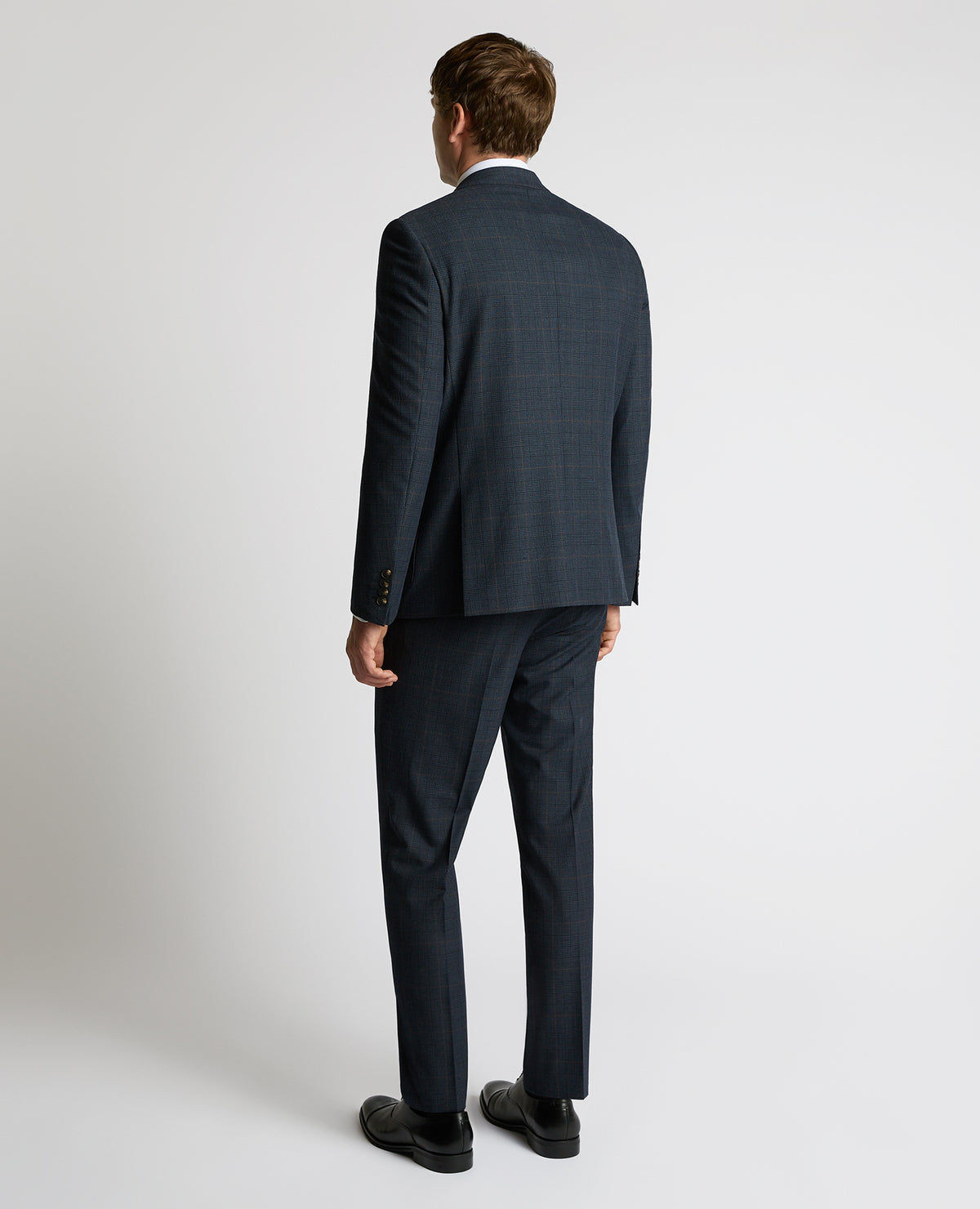 Man wearing a navy Slim Fit Double-Breasted Stretch Jacket