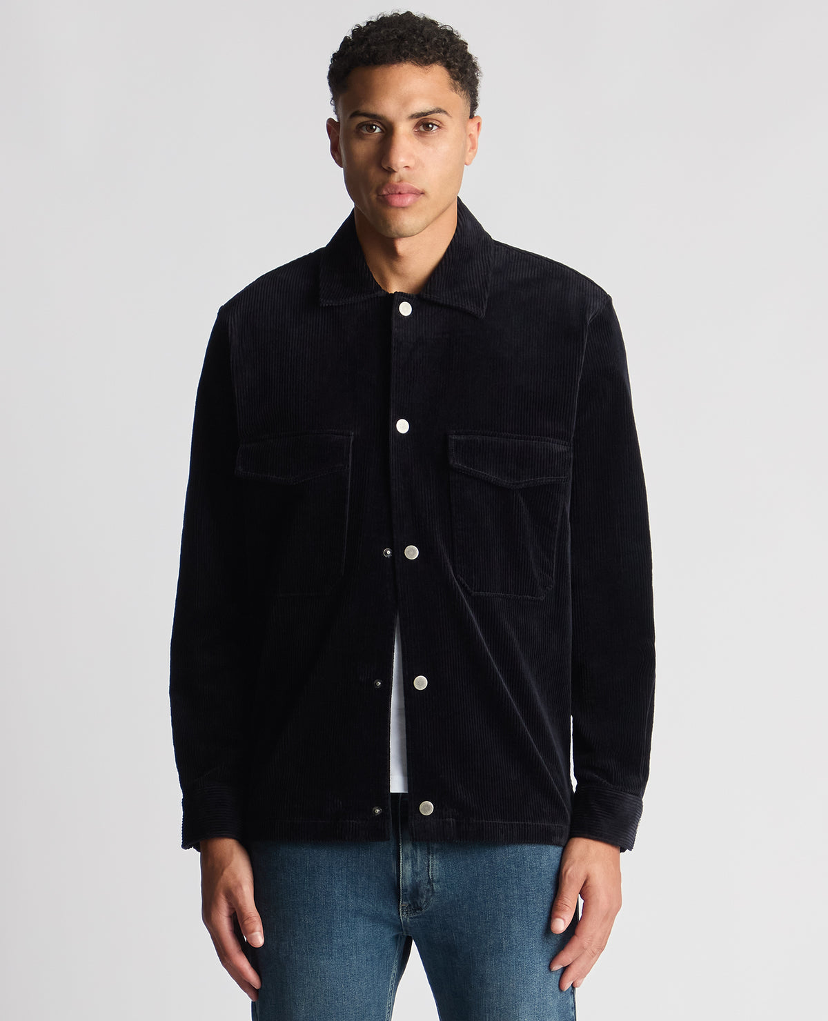 Man wearing a navy Tapered Fit Corduroy Overshirt
