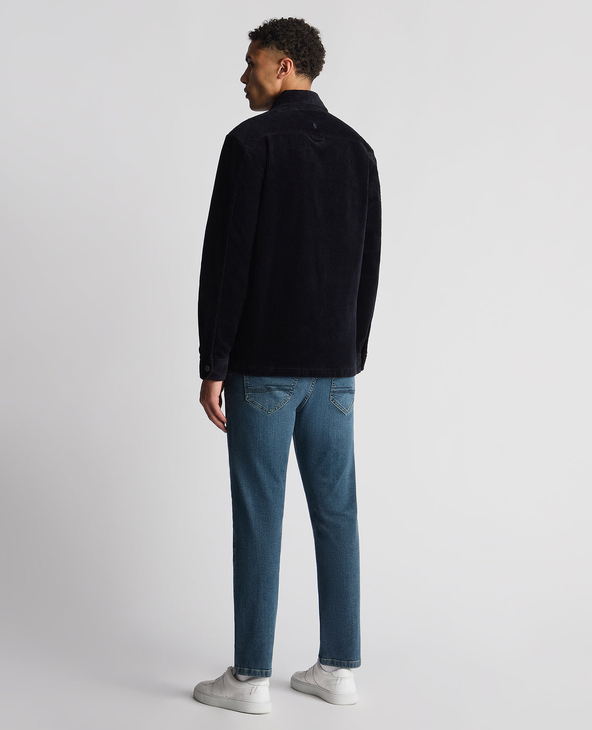 Man wearing a navy Tapered Fit Corduroy Overshirt