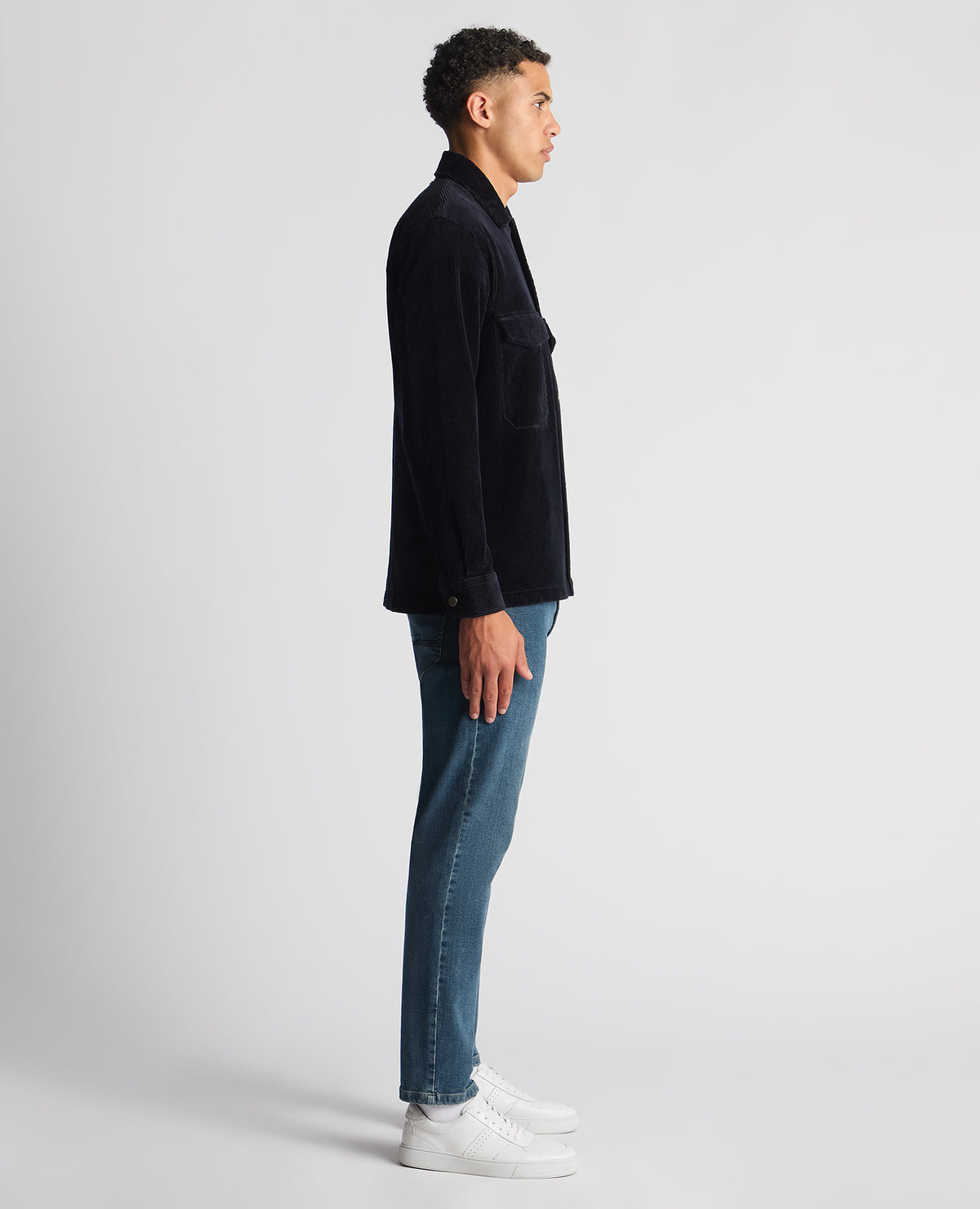 Man wearing a navy Tapered Fit Corduroy Overshirt