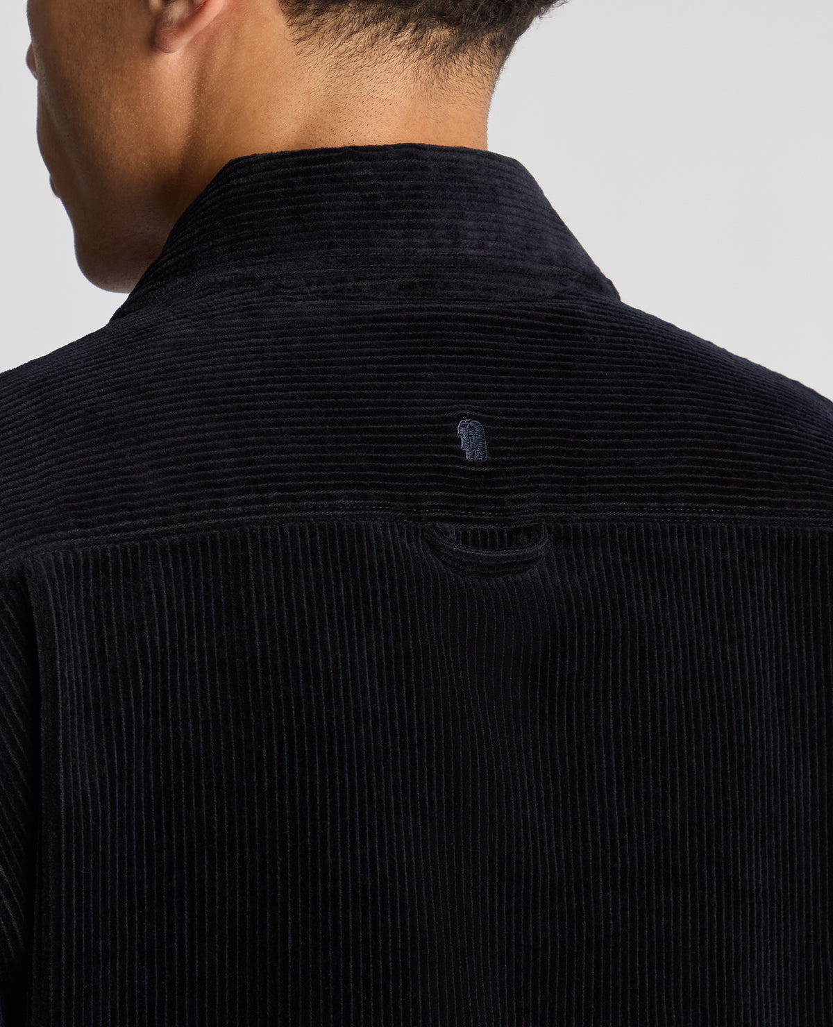 Man wearing a navy Tapered Fit Corduroy Overshirt