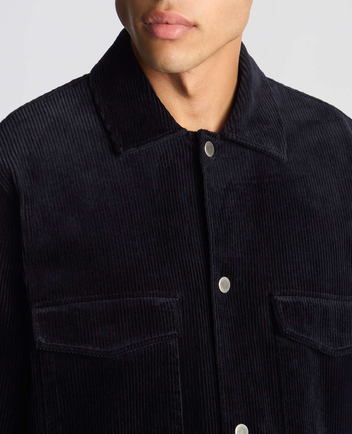 Man wearing a navy Tapered Fit Corduroy Overshirt