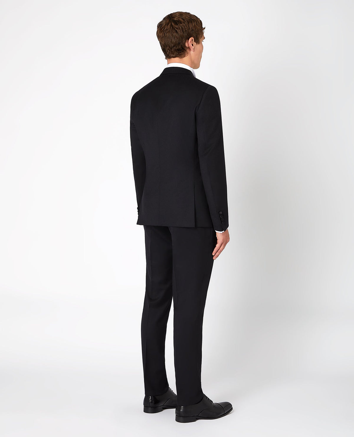 Man wearing a black Slim Fit Wool-Rich Mix and Match Dinner Suit