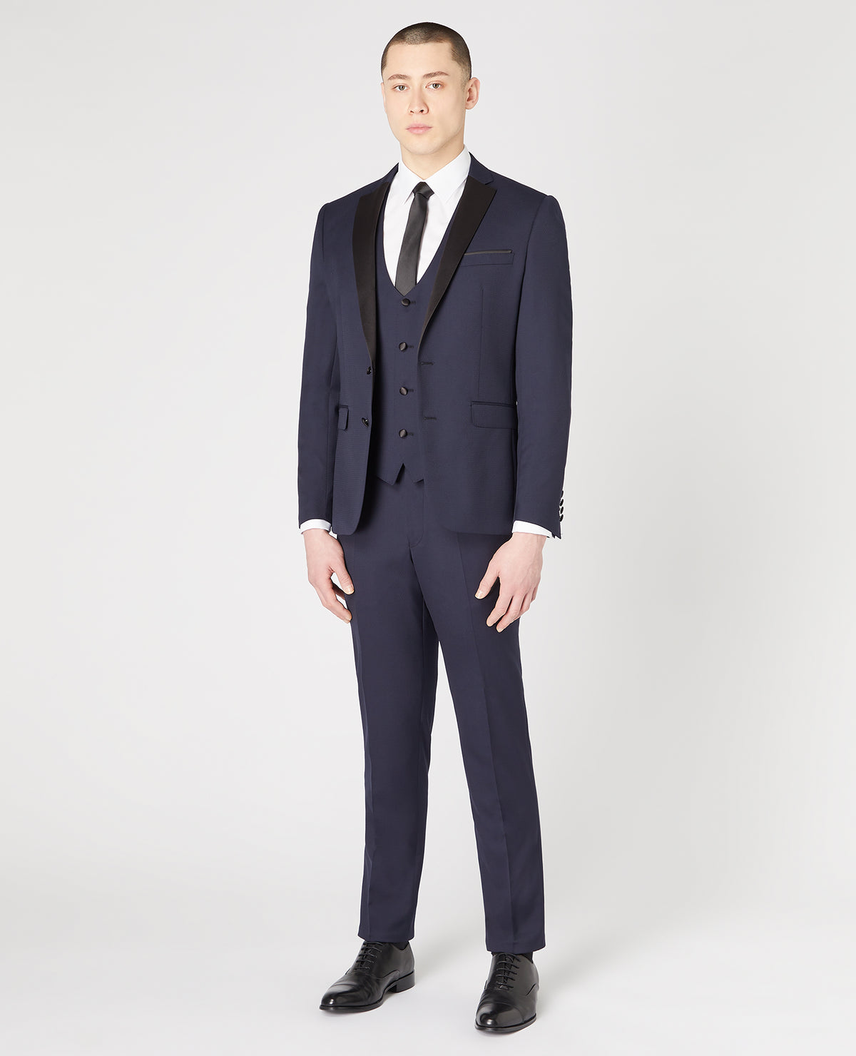 Man wearing a navy Slim Fit Wool-Rich Mix and Match Dinner Suit Jacket