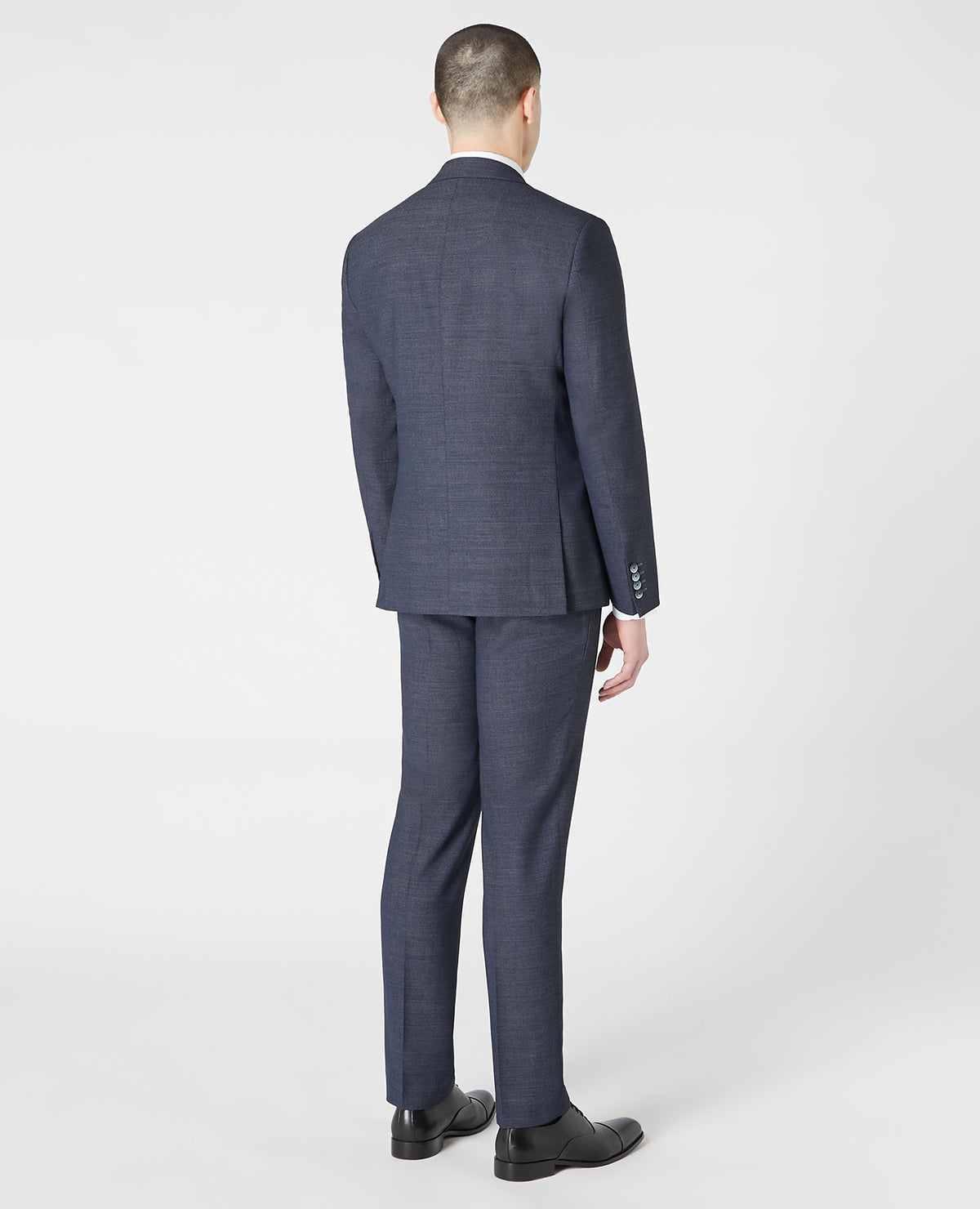 Man wearing a blue Tapered Fit Wool-Rich Stretch Mix and Match Suit Jacket