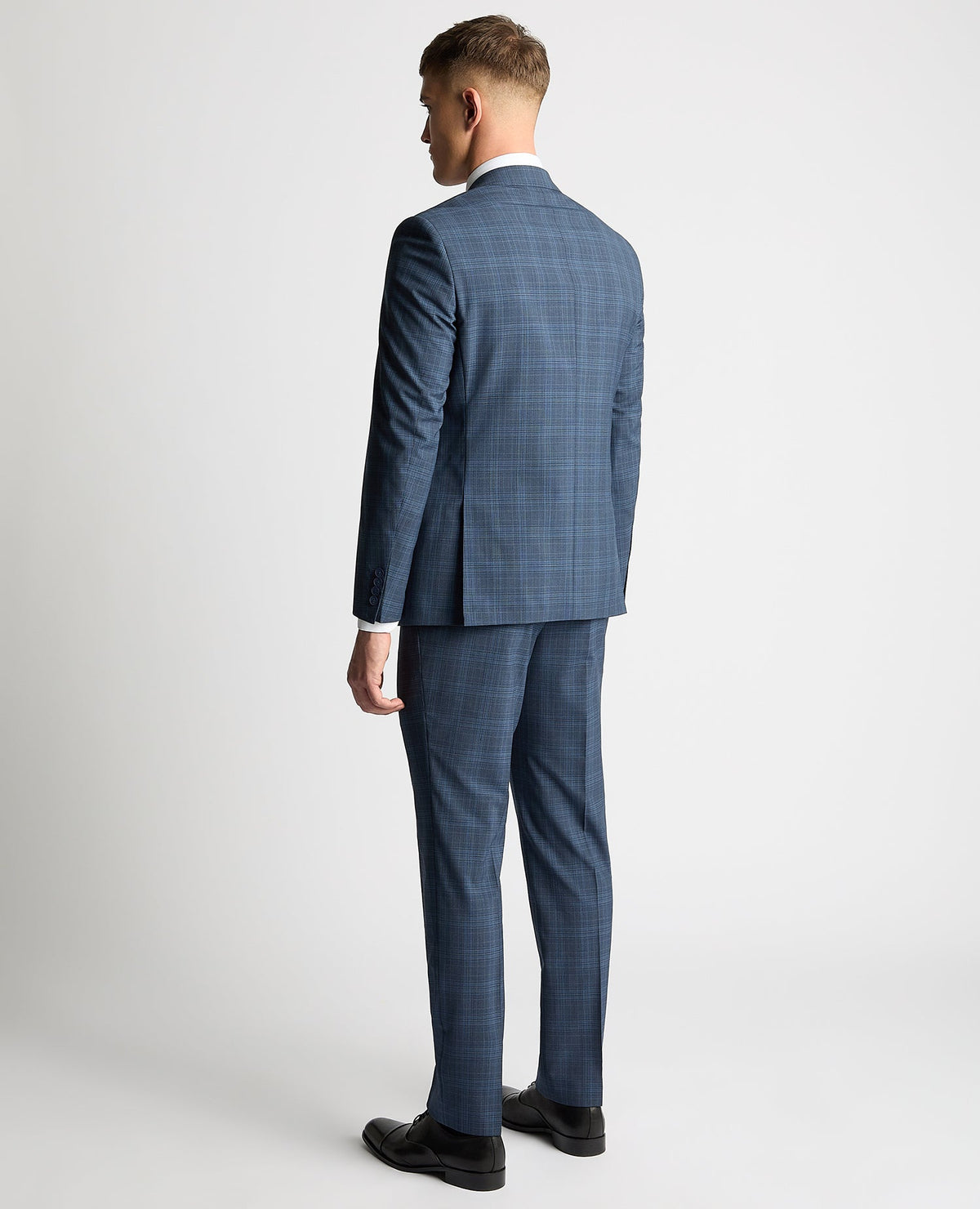Man wearing a blue Tapered Fit Checked Wool Blend Mix and Match Suit