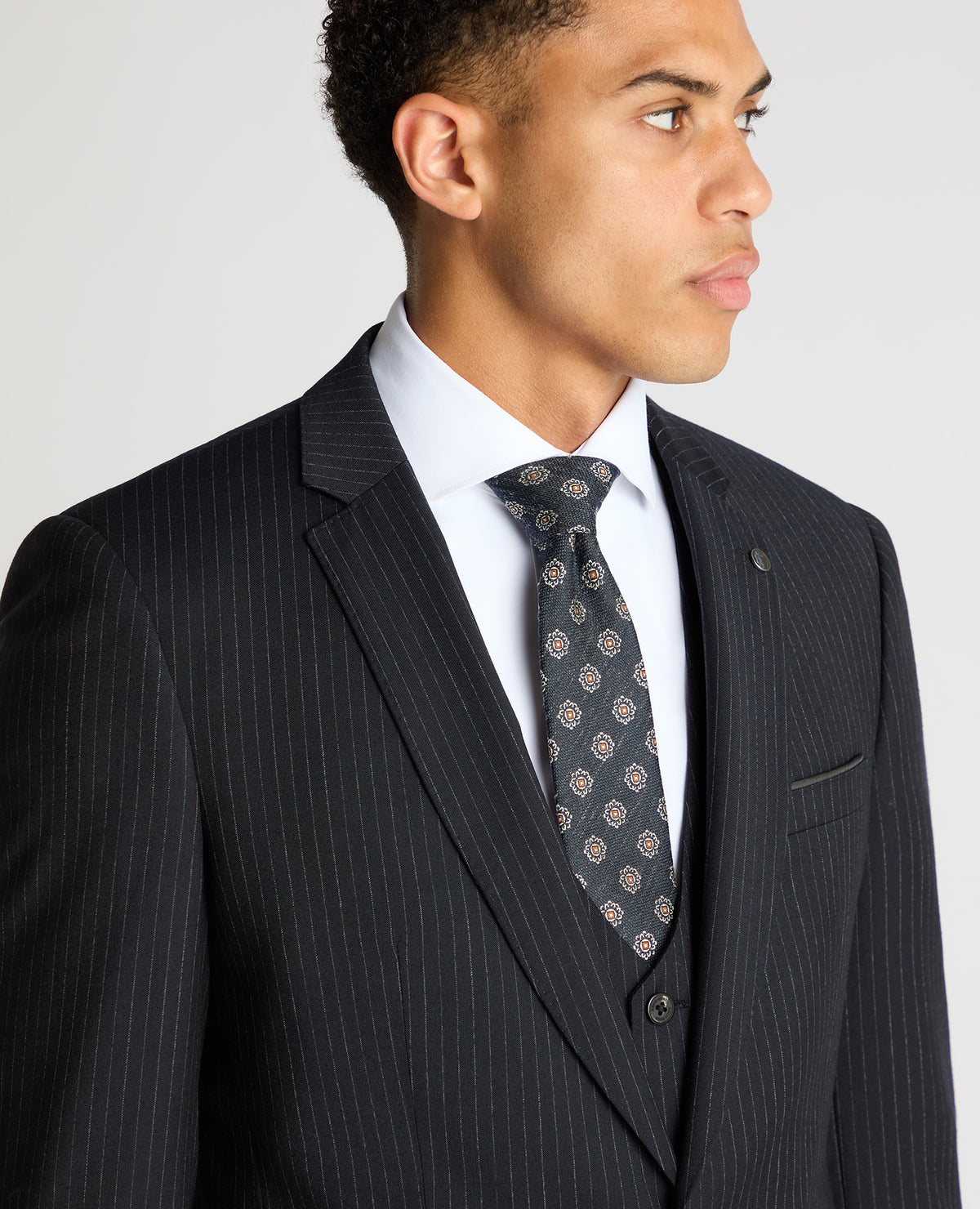 Man wearing a navy Slim Fit Pinstripe Wool Rich Suit