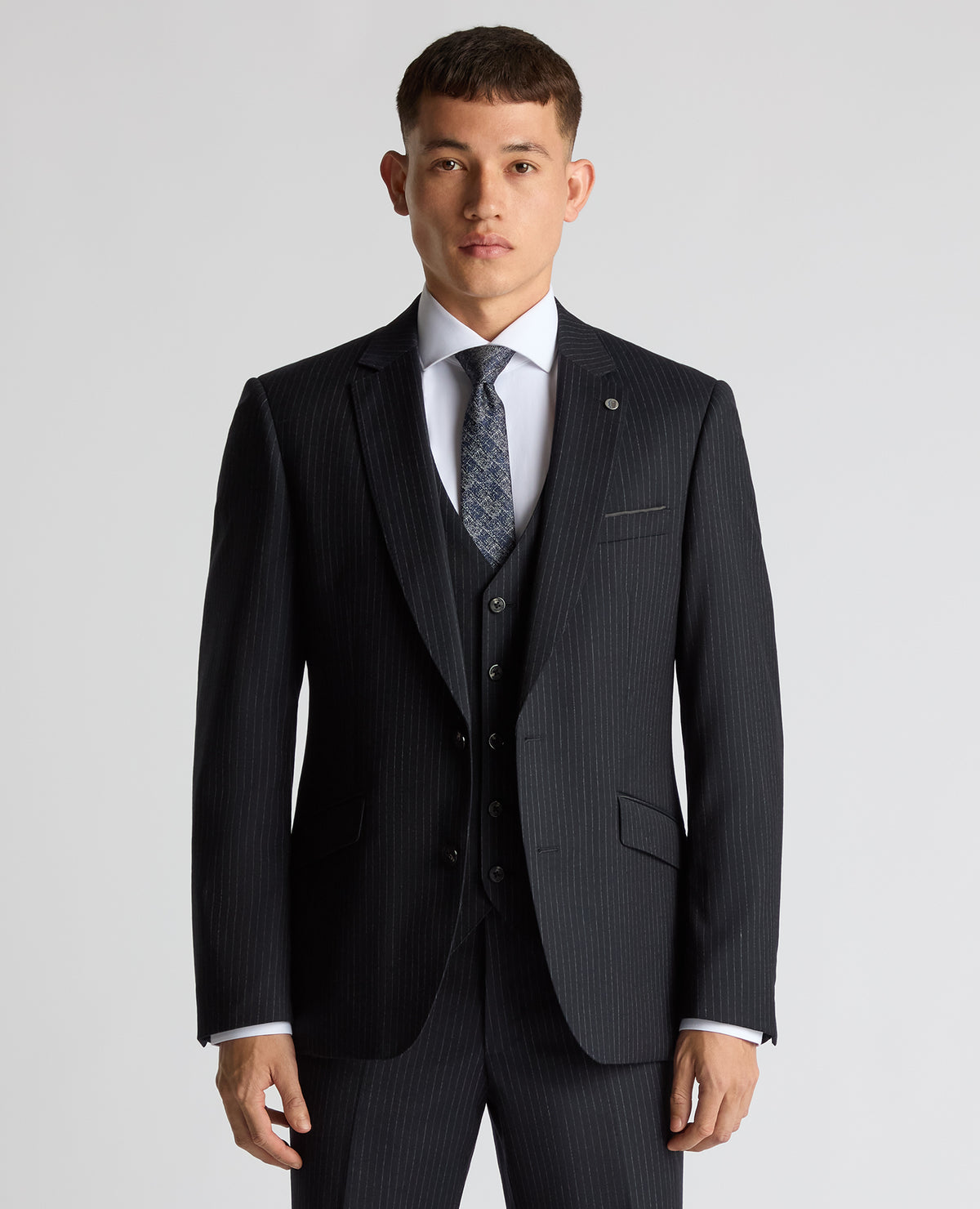 Man wearing a navy Tapered Fit Wool Rich Suit