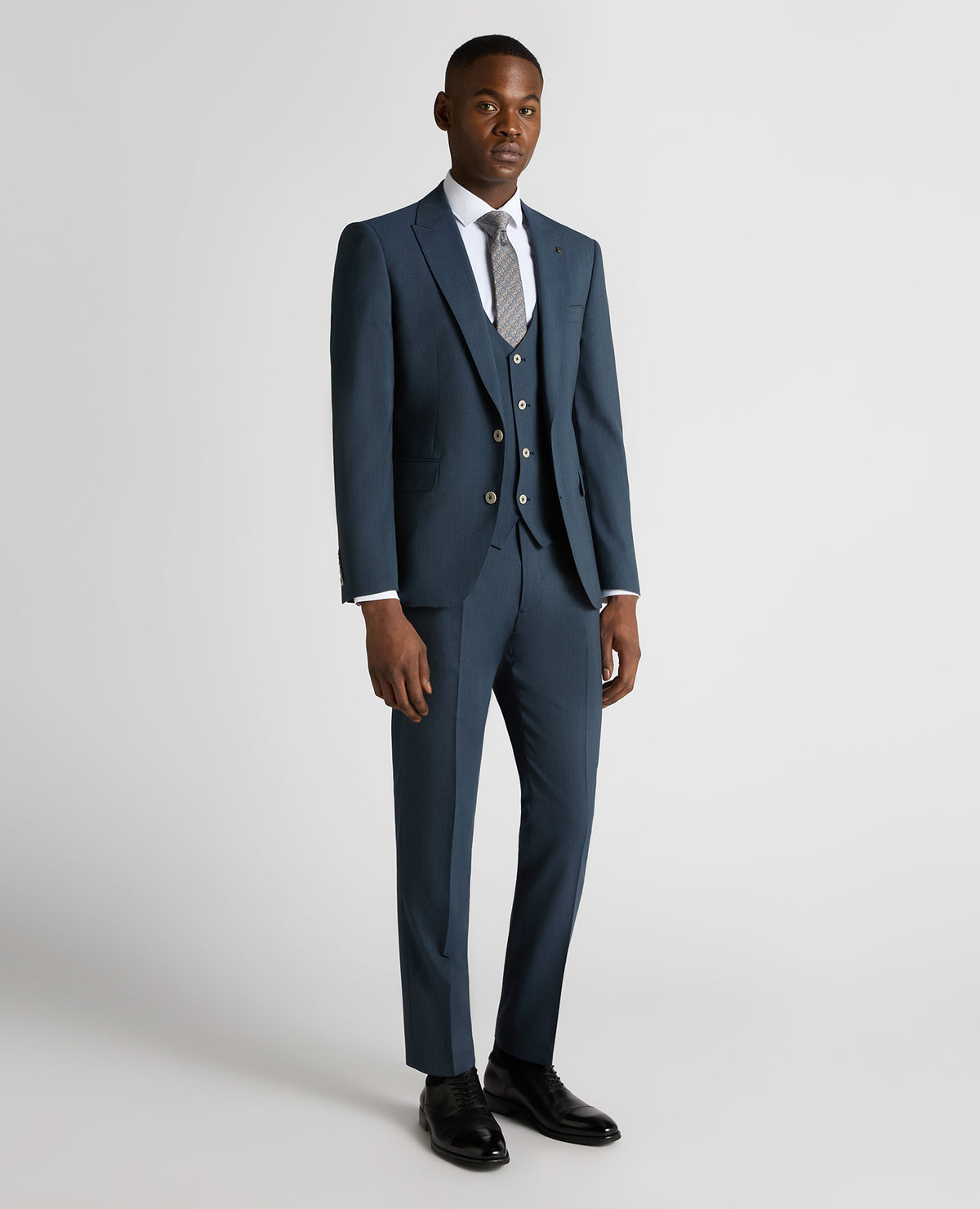 Man wearing a blue Tapered Fit Wool-Stretch Mix and Match Suit Jacket