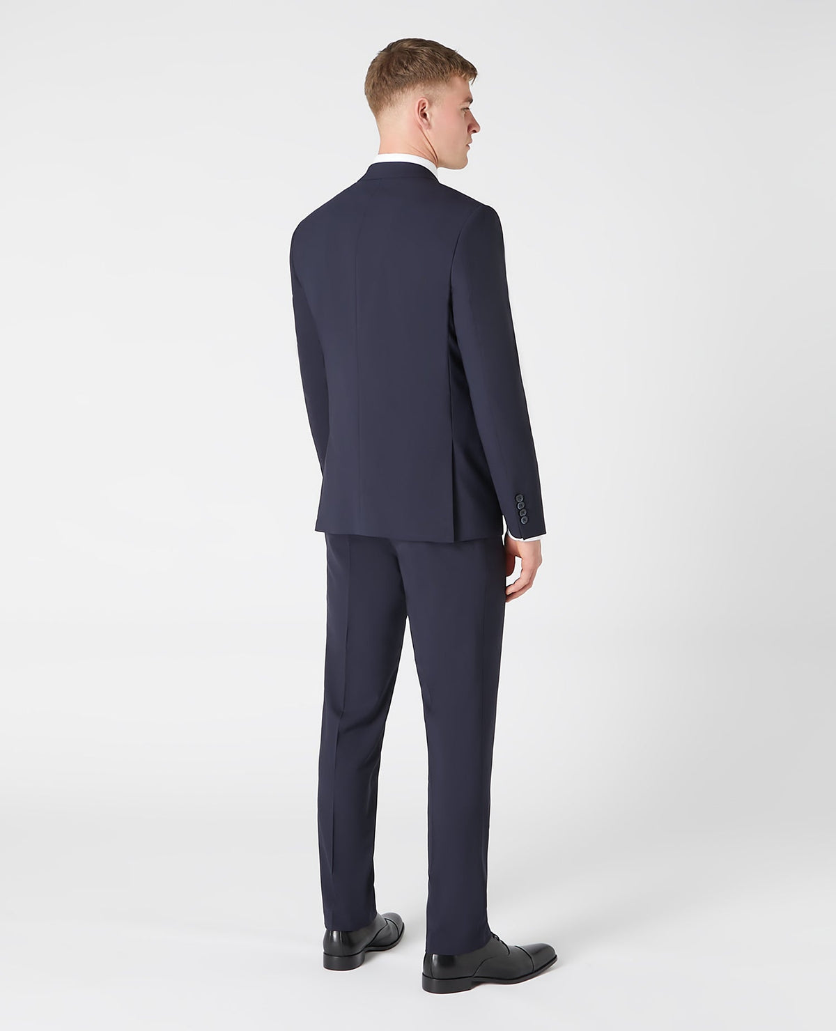 Man wearing a navy Tapered fit wool blend stretch mix and match suit jacket