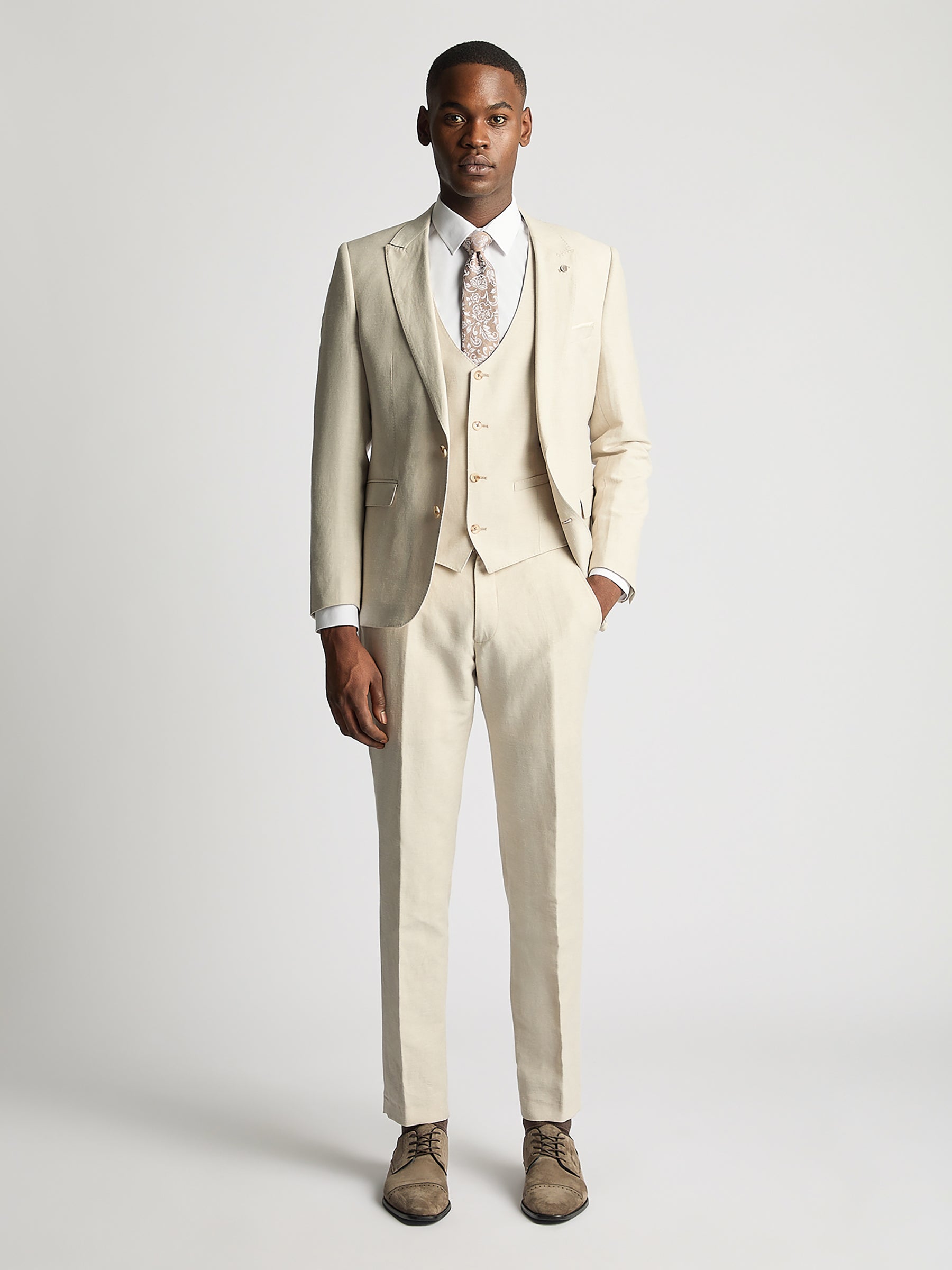 Man wearing a cream suit