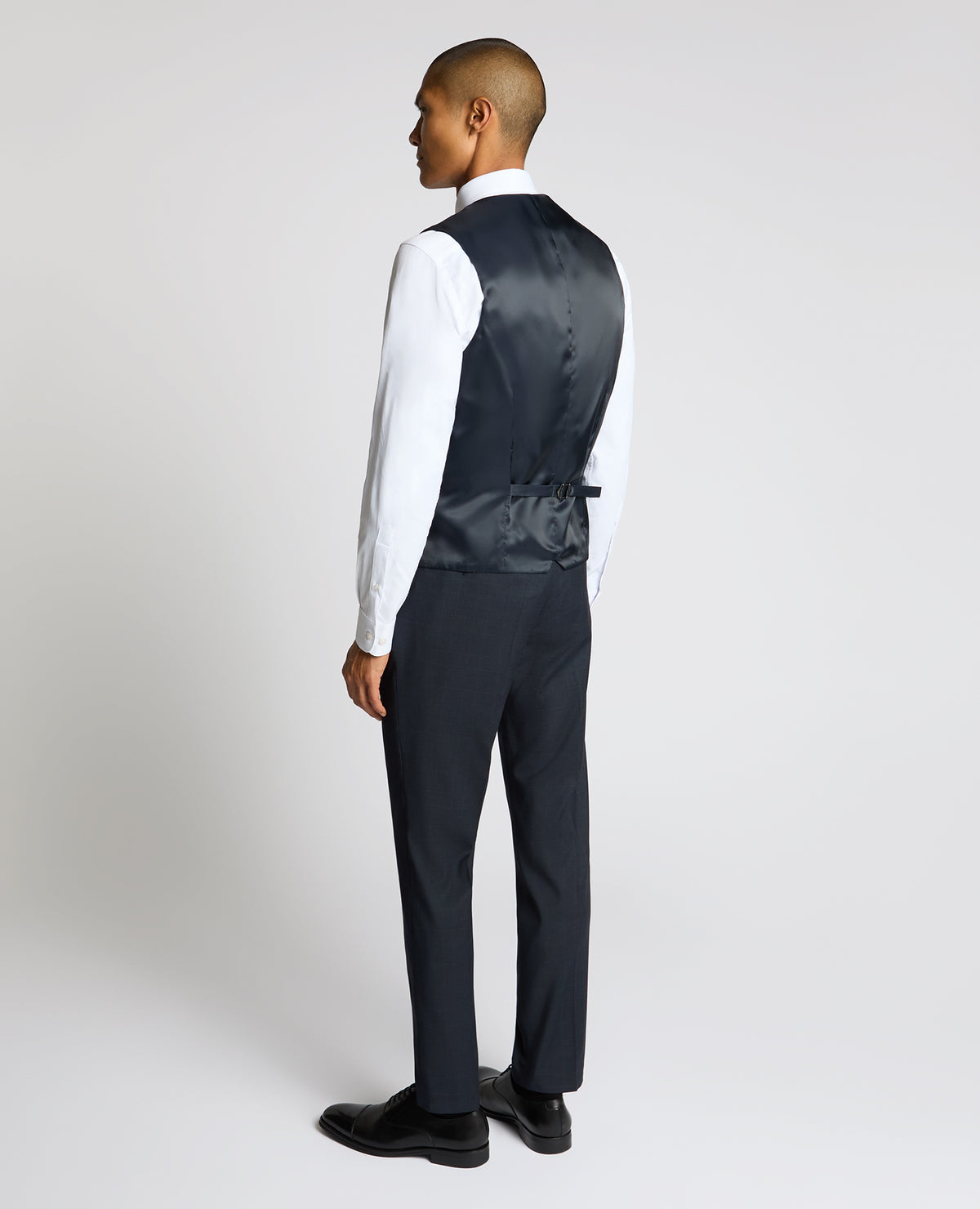 Man wearing a navy Slim Fit Stretch Waistcoat